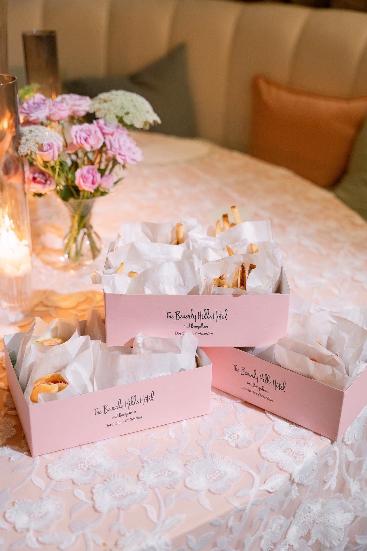 Pink reception favor boxes with custom labels on a lace table for a Magnolia Boone Paperie wedding